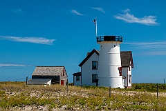 Headless Stage Harbor Lighthouse on Beach Sand